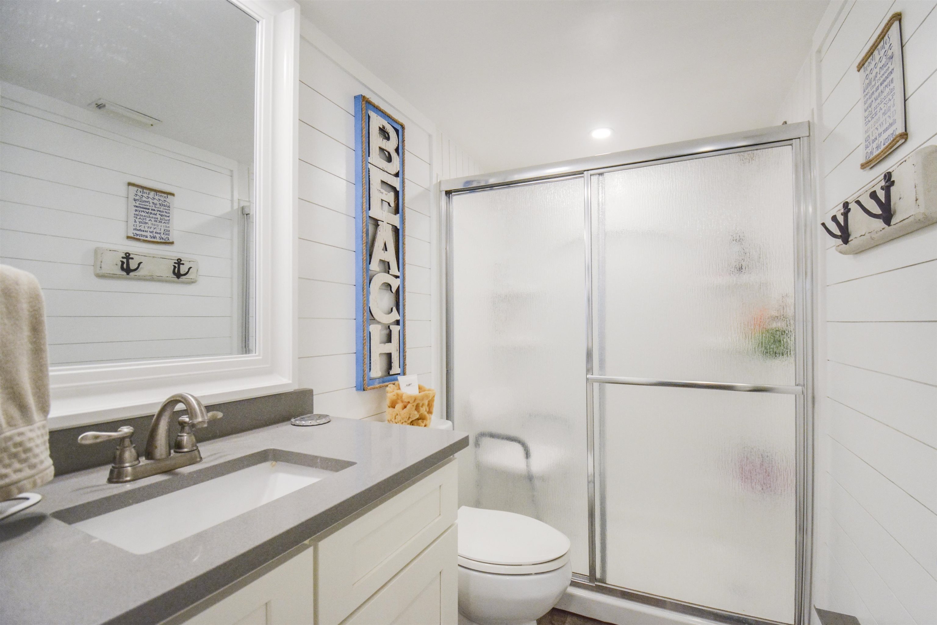 6300 A1A South St. Augustine, FL 32080 - Photo 29 of 42 a bathroom with a granite countertop sink toilet and shower