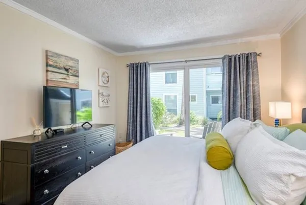 a bedroom with a bed window and table