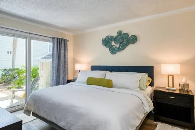 a bedroom with a bed window and a potted plant