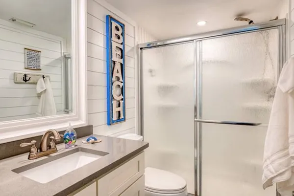 a bathroom with a sink toilet and shower