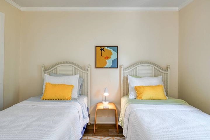 6300 A1A South St. Augustine, FL 32080 - Photo 36 of 42 a bedroom with a bed and lamp on dresser