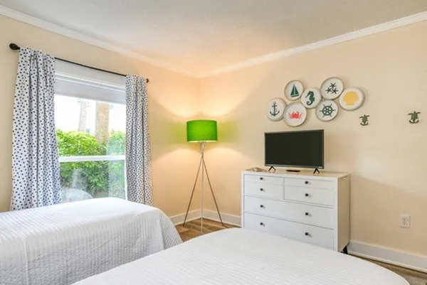 a bedroom with a bed and a flat screen tv