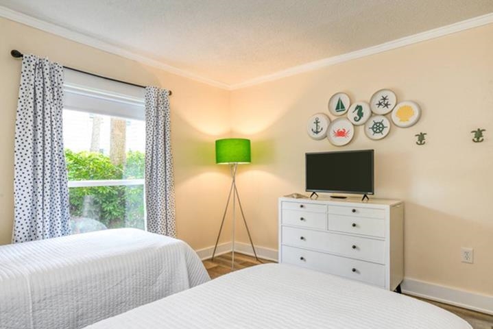6300 A1A South St. Augustine, FL 32080 - Photo 37 of 42 a bedroom with a bed and a flat screen tv