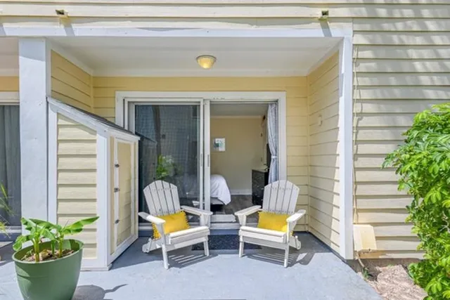 a view of two chairs in patio of the house
