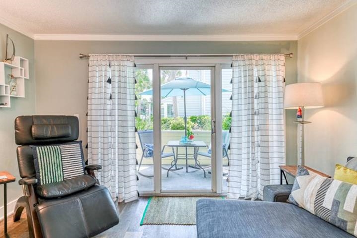6300 A1A South St. Augustine, FL 32080 - Photo 9 of 42 a living room with furniture and a floor to ceiling window