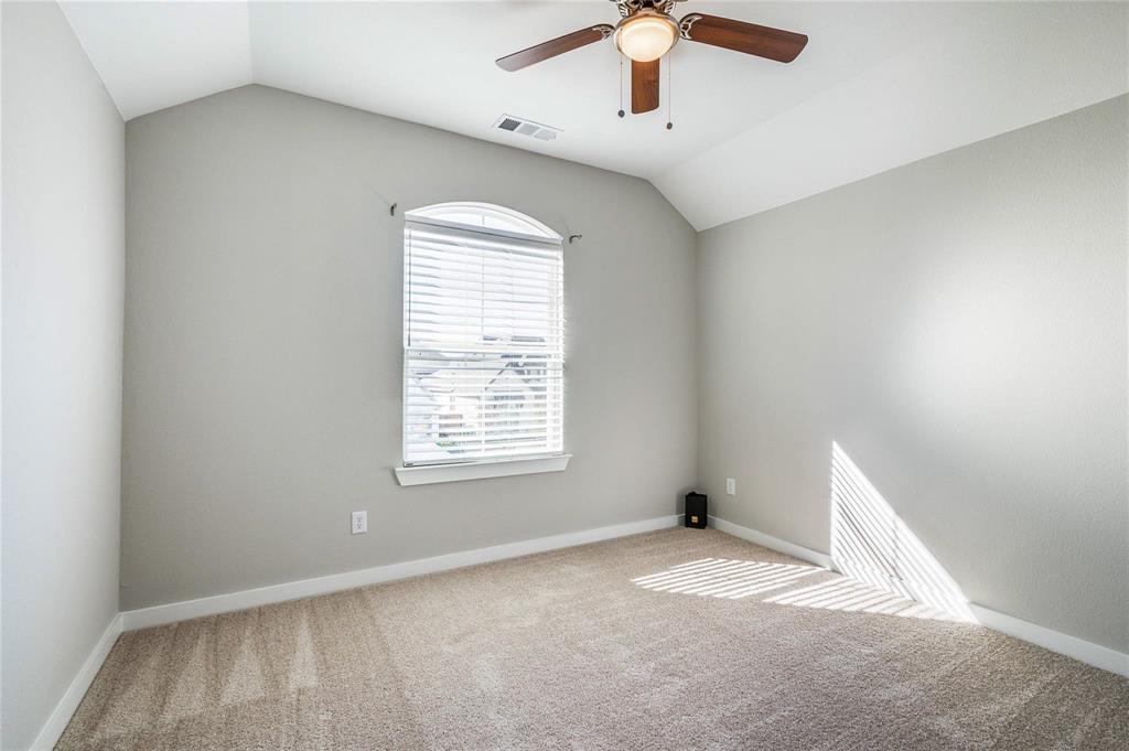 1309 Old Rocksprings Pass Mansfield, TX 76063 - Photo 27 of 36 Vaulted ceiling bedroom featuring an arched window with blinds, a ceiling fan, and neutral carpet flooring
