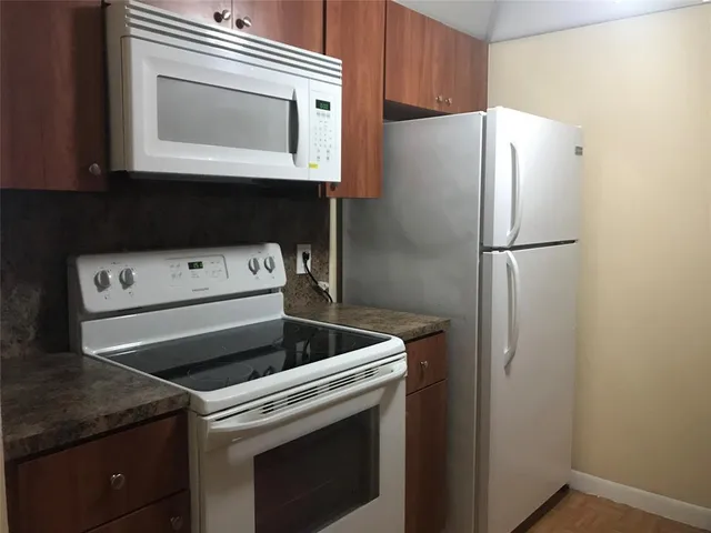 a white refrigerator freezer sitting inside of a kitchen