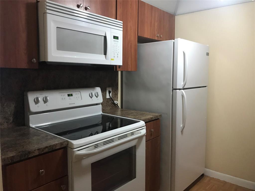 a white refrigerator freezer sitting inside of a kitchen