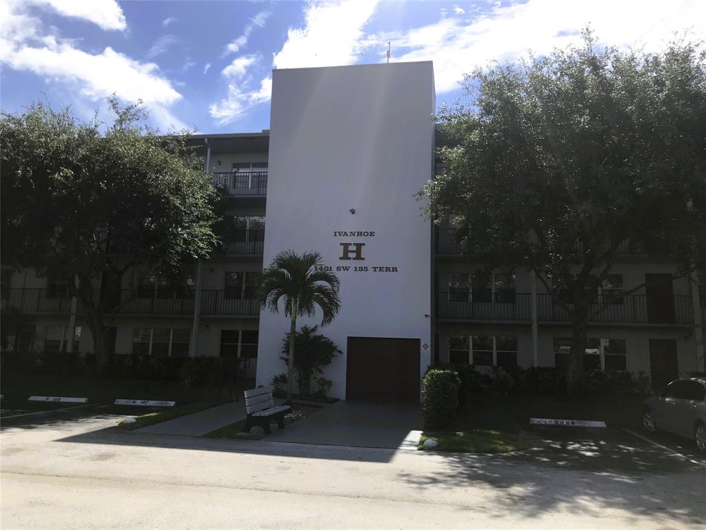 1401 Southwest 135th Terrace, Unit 307H Pembroke Pines, FL 33027 - Photo 11 of 13 a building with trees in front of it