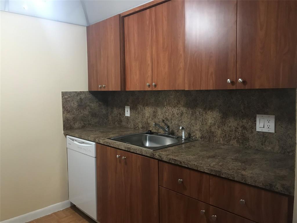 1401 Southwest 135th Terrace, Unit 307H Pembroke Pines, FL 33027 - Photo 2 of 13 a kitchen with a sink and cabinets