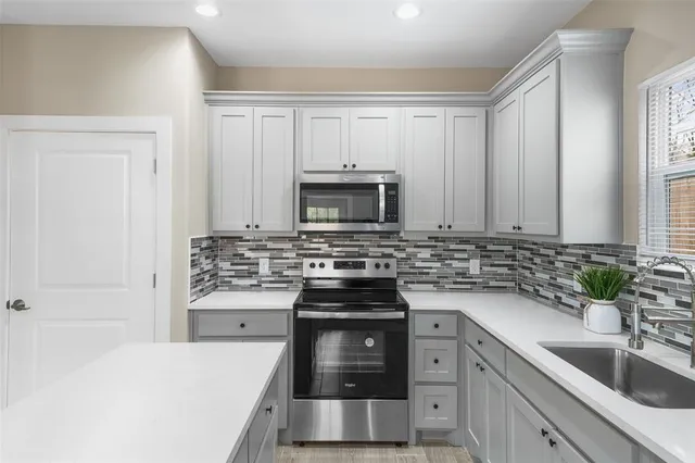 a kitchen with a stove and a sink