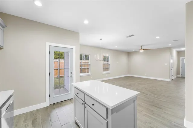 a view of a kitchen with a sink and a refrigerator