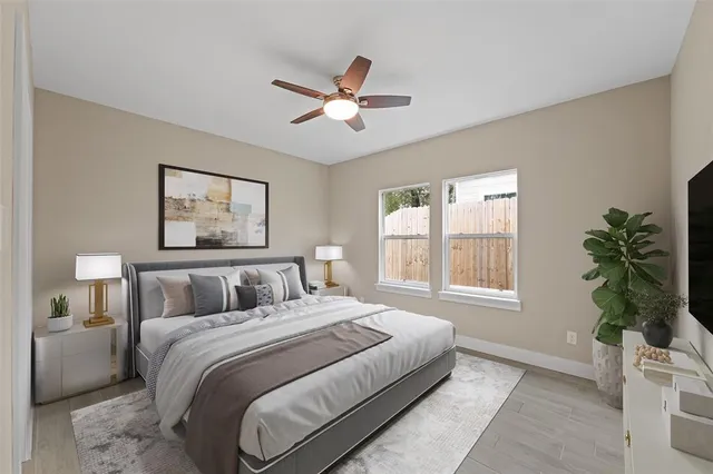 a bedroom with a large bed and a window