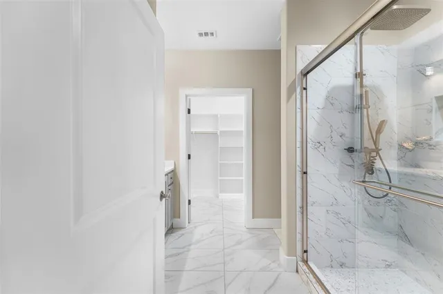 a bathroom with a shower and a sink