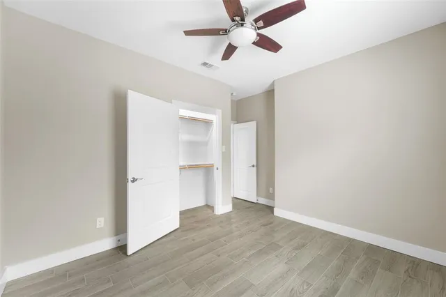 a view of empty room with wooden floor