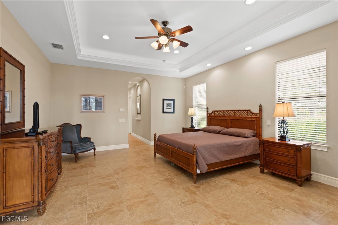 6057 Calusa Rdg Trail Bokeelia, FL 33922 - Photo 16 of 45 a bedroom with a bed and a chandelier
