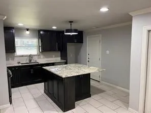 a kitchen with a sink a stove a refrigerator and cabinets