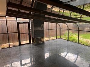 8926 Angleton Place Dallas, TX 75243 - Photo 9 of 19 a view of an empty room with a window