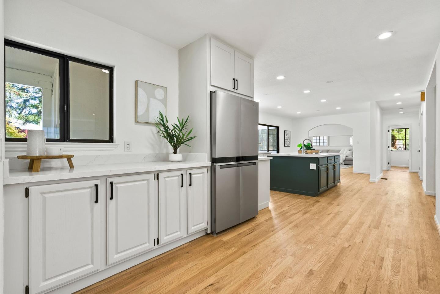 1475 Oak Rim Drive Hillsborough, CA 94010 - Photo 15 of 72 a large white kitchen with kitchen island a sink a counter top space stainless steel appliances and a window