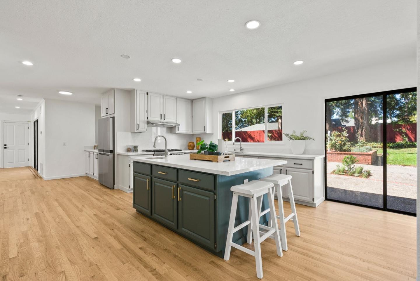 1475 Oak Rim Drive Hillsborough, CA 94010 - Photo 17 of 72 a kitchen with stainless steel appliances granite countertop wooden cabinets and window