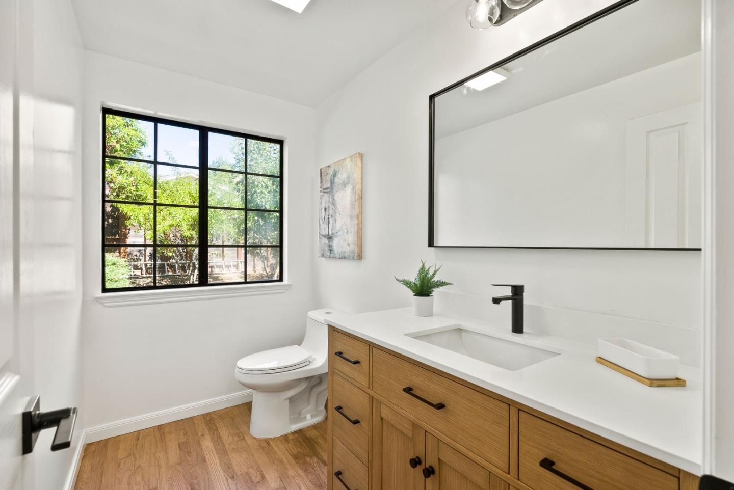 1475 Oak Rim Drive Hillsborough, CA 94010 - Photo 26 of 72 a bathroom with a sink a toilet and a mirror