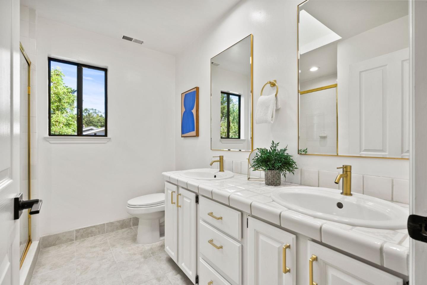1475 Oak Rim Drive Hillsborough, CA 94010 - Photo 35 of 72 a bathroom with a double vanity sink toilet and a mirror