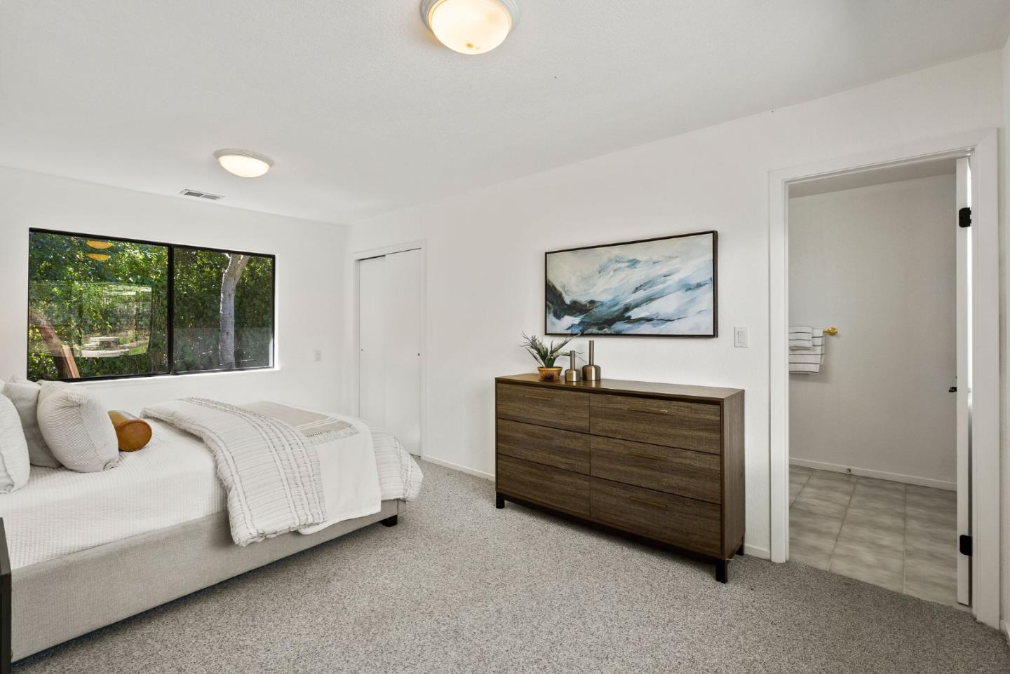 1475 Oak Rim Drive Hillsborough, CA 94010 - Photo 57 of 72 a bedroom with a bed lamp and window