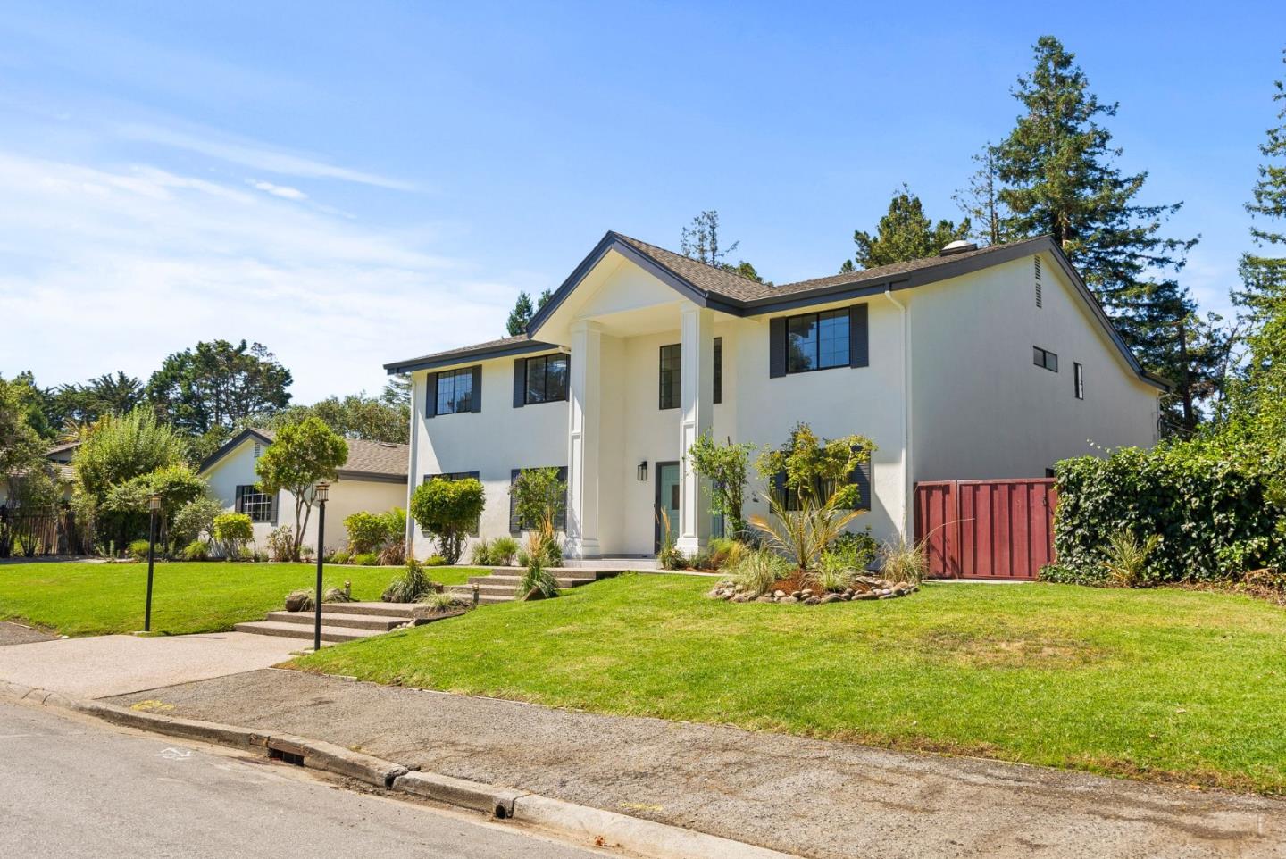 1475 Oak Rim Drive Hillsborough, CA 94010 - Photo 63 of 72 a front view of a house with a garden and plants