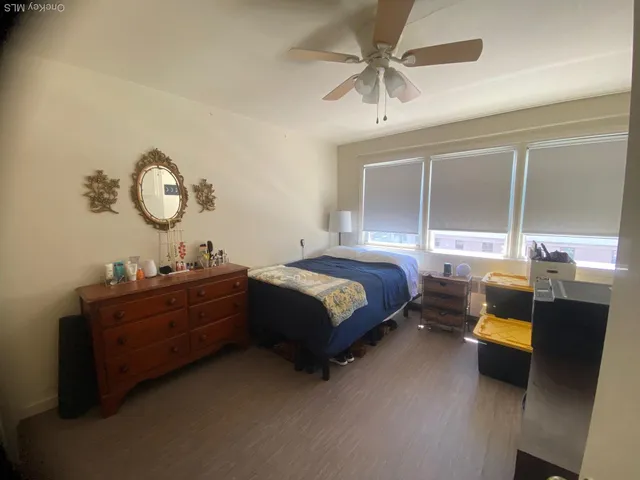 a bedroom with a bed dresser and a window