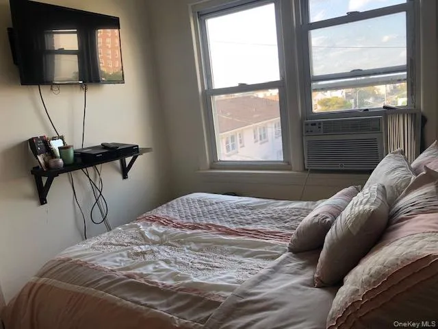 a bedroom with a bed and window