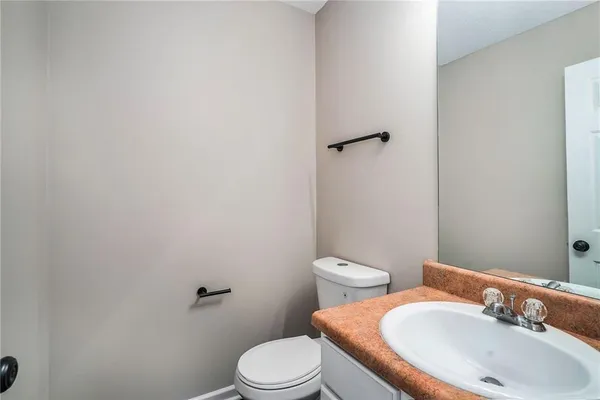 a white toilet sitting next to a bathroom sink
