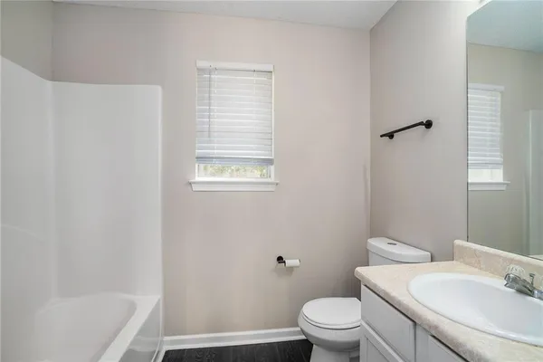 a bathroom with a sink a toilet and a bathtub