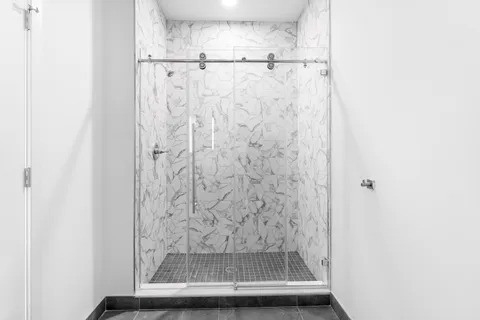 a bathroom with a glass shower door