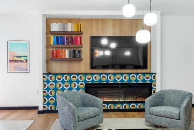a living room with fireplace furniture and a flat screen tv