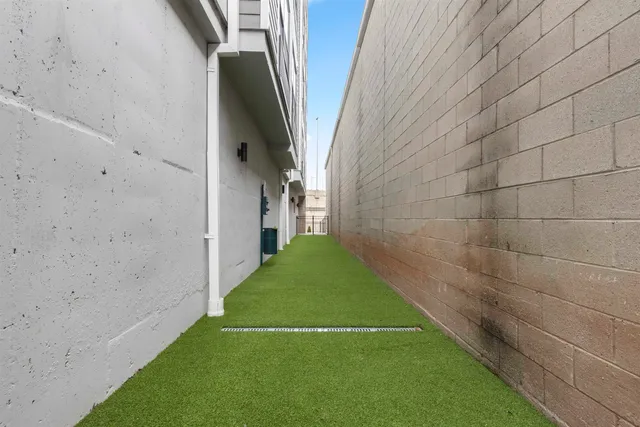 a view of a pathway both side of a house