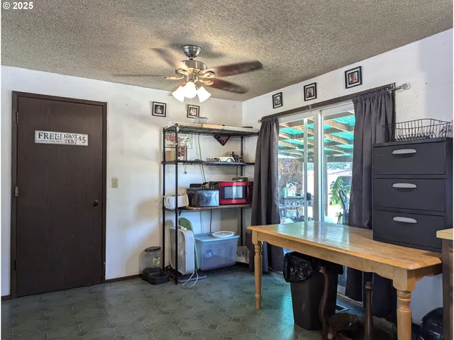 a room with a table chairs and a window