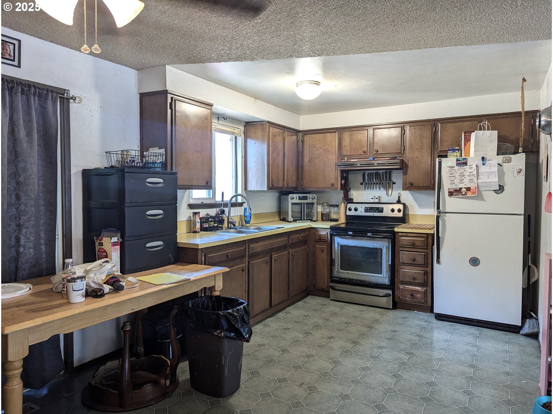 47696 West 1st Street Oakridge, OR 97463 - Photo 14 of 20 a kitchen with a refrigerator stove and sink