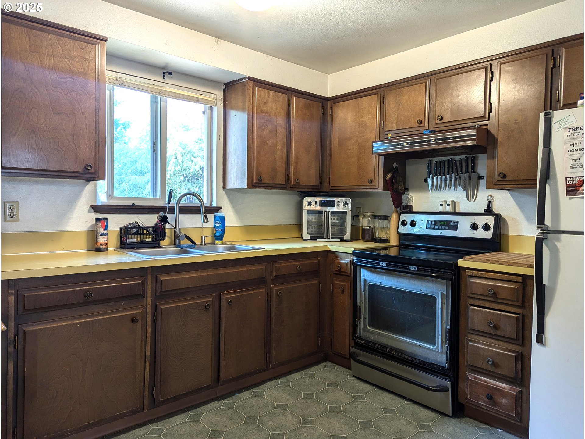 47696 West 1st Street Oakridge, OR 97463 - Photo 15 of 20 a kitchen with granite countertop a stove cabinets and stainless steel appliances