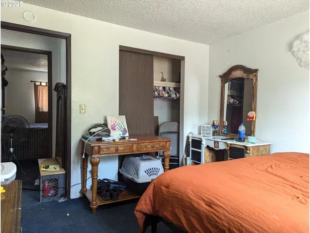 a bedroom with a bed and a mirror