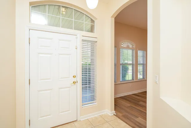 a view of a room with wooden floor and a ceiling fan