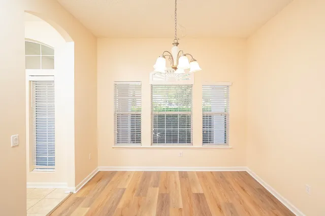 a kitchen with granite countertop wooden cabinets and white appliances