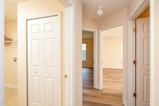 a view of a small space with wooden floor and a window