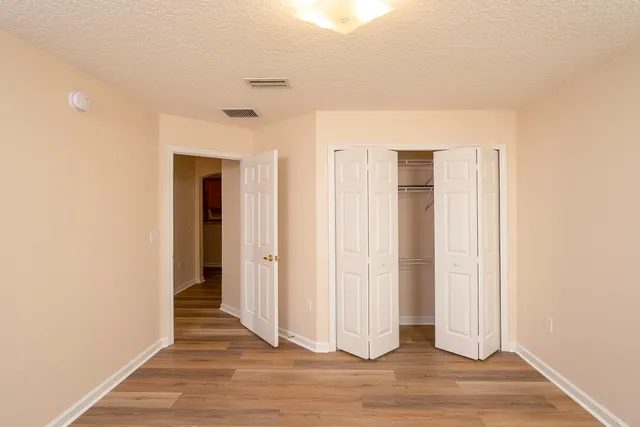 a view of a livingroom with wooden floor and entryway