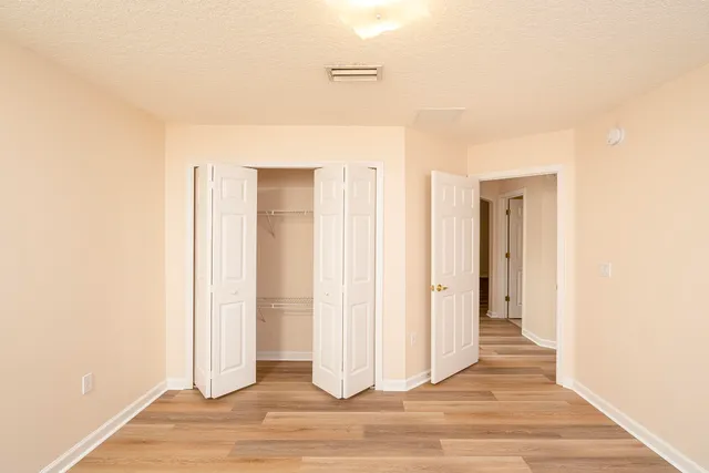 a view of a room with wooden floor