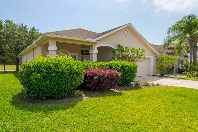 a view of a house with garden and a garden