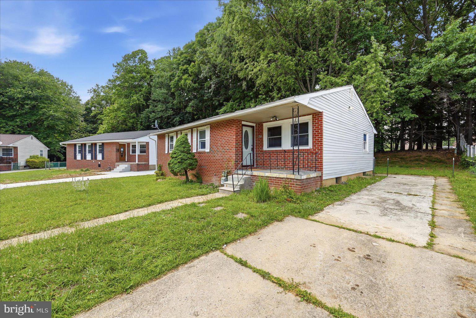 9110 Meadow Heights Road Randallstown, MD 21133 - Photo 2 of 39 Charming home with lush greenery backdrop.