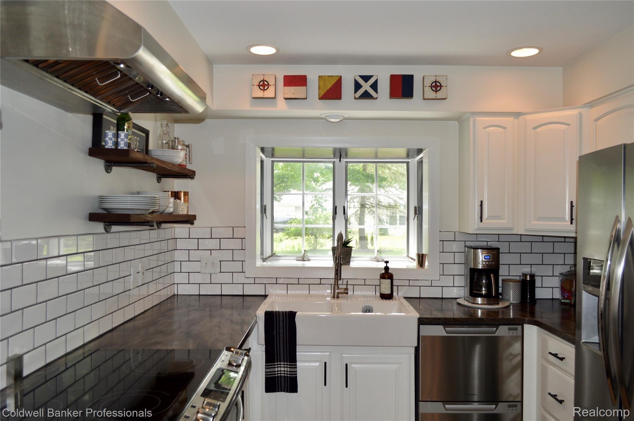 34501 Quaker Valley Road Farmington, MI 48331 - Photo 5 of 43 Kitchen with Stainless Steel, Subway tile, Farmers Sink, Atrium window