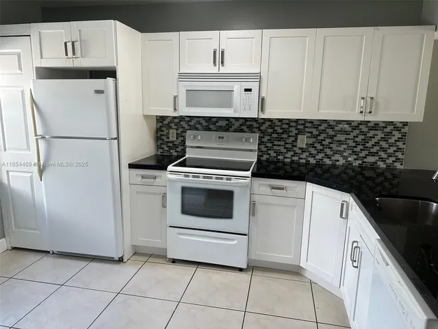 a kitchen with cabinets and appliances