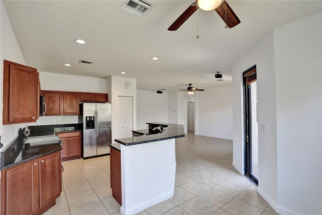 11331 Southwest 240 Lane Homestead, FL 33032 - Photo 18 of 92 a kitchen with stainless steel appliances granite countertop a refrigerator and a stove