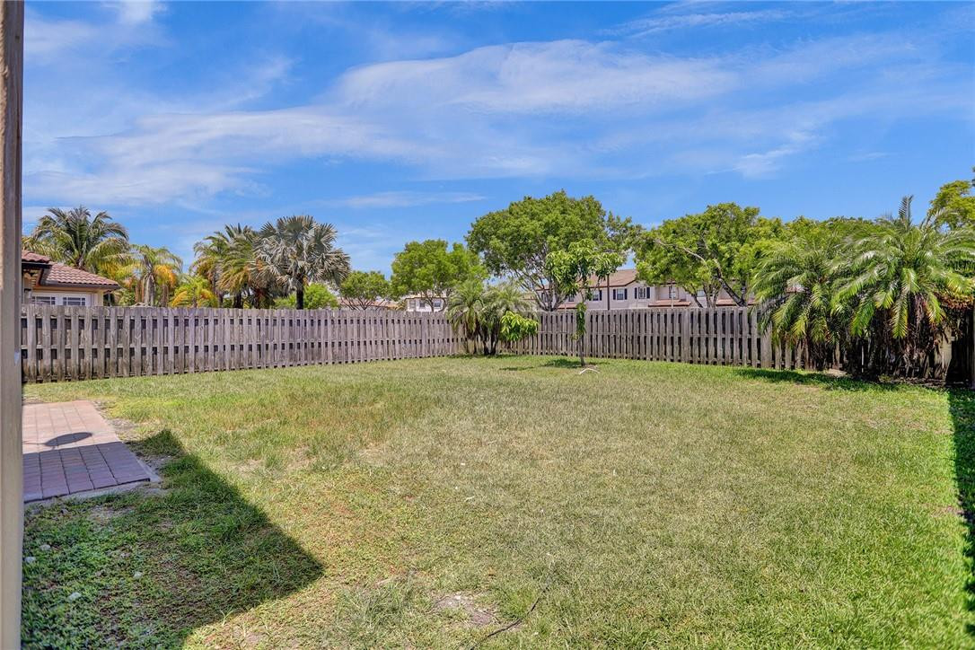 11331 Southwest 240 Lane Homestead, FL 33032 - Photo 3 of 92 a view of a garden with a building in the background